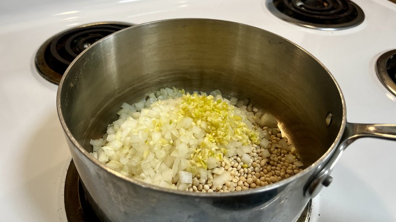 couscous and alliums in pan