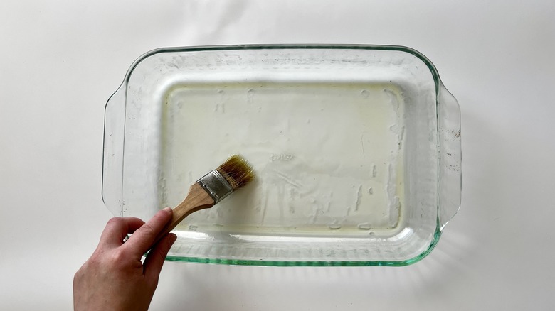 brushing glass pan with oil