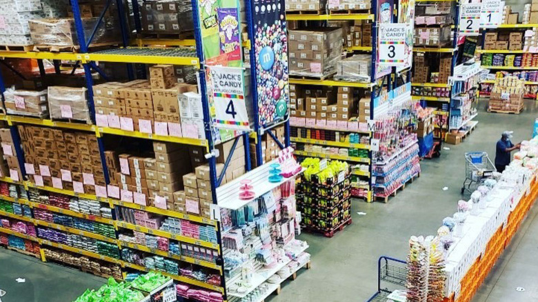 Warehouse shelves and floor filled with bulk candy.