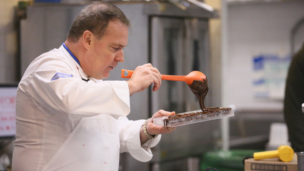 Jacques Torres pouring chocolate into molds