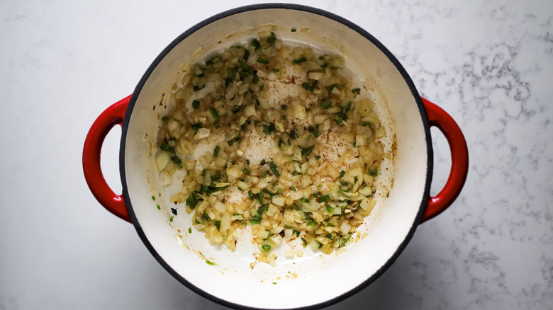 onion and jalapeno cooking in Dutch oven