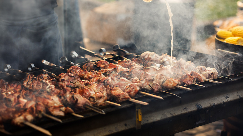 shish kabobs cooking on a grill