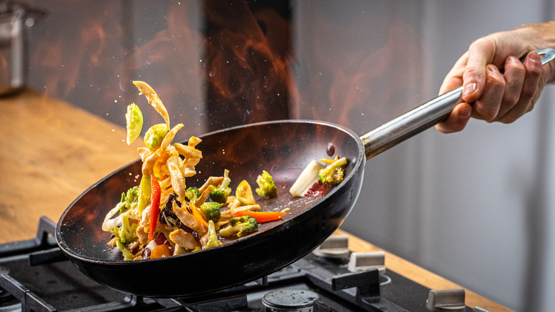 stir-fry flipping in a pan