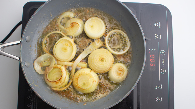 Jamie Oliver's steak sarnie with a twist onions cooking 