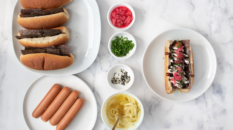 hot dogs with buns and garnishes