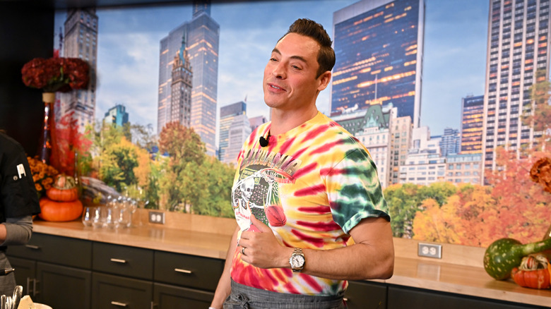 Jeff Mauro smiling in a tie-dyed shirt