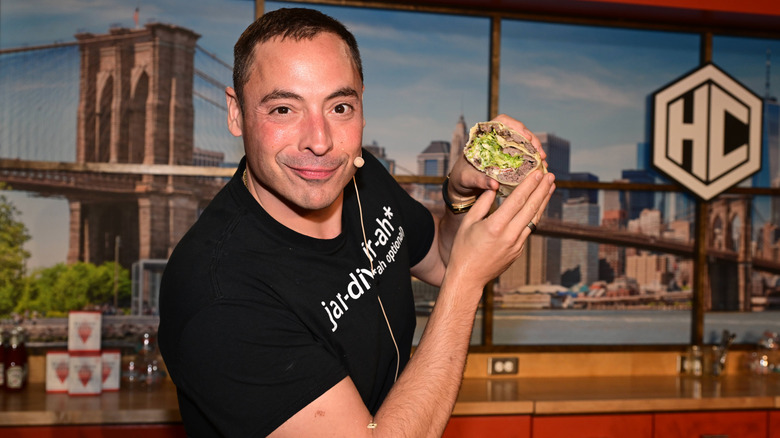 Jeff Mauro holding half a wrap