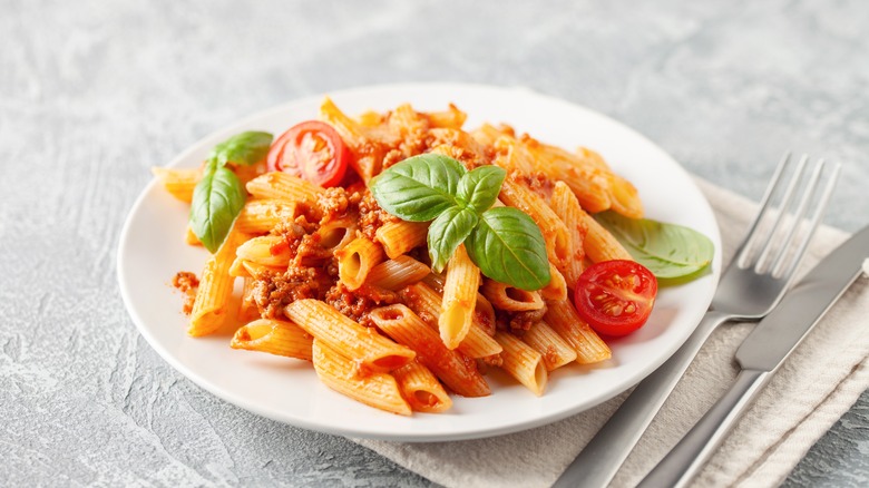 Plate of pasta with tomatoes and herbs