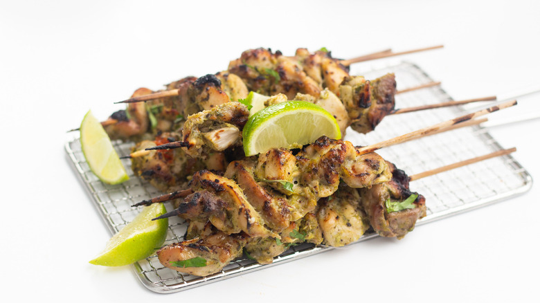 Juicy jerk chicken kabobs on wire tray