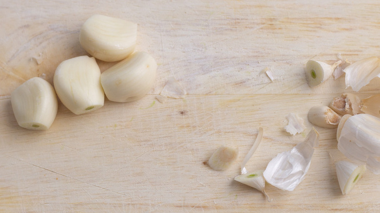 Peeled garlic cloves on cutting board