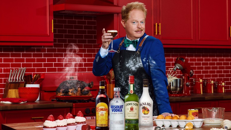 Jesse Tyler Ferguson posing with cocktail in kitchen