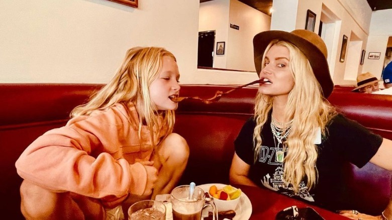 Simpson and her daughter eating bacon