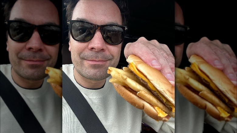 Jimmy Fallon eating a hamburger with French fries