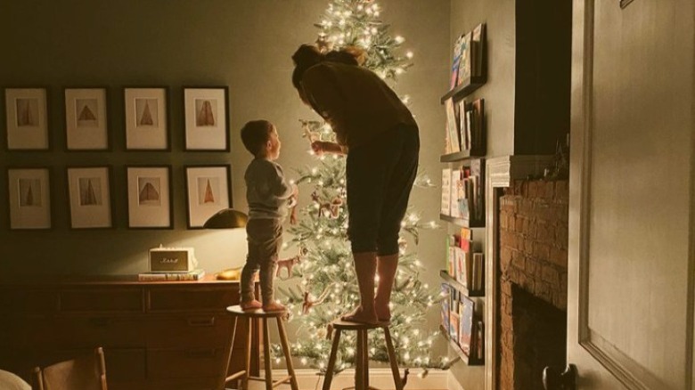 Joanna Gaines decorating a Christmas tree with her son