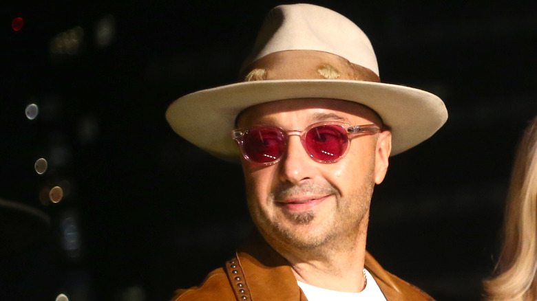 Joe Bastianich wearing sunglasses looking off to the side