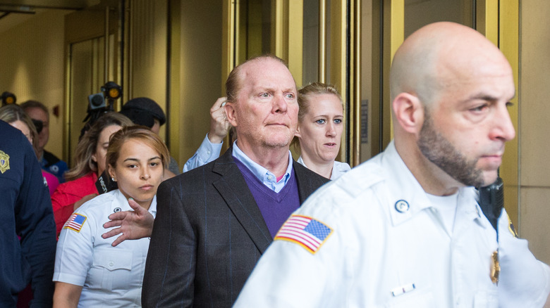 Mario Batali being escorted out of court by police