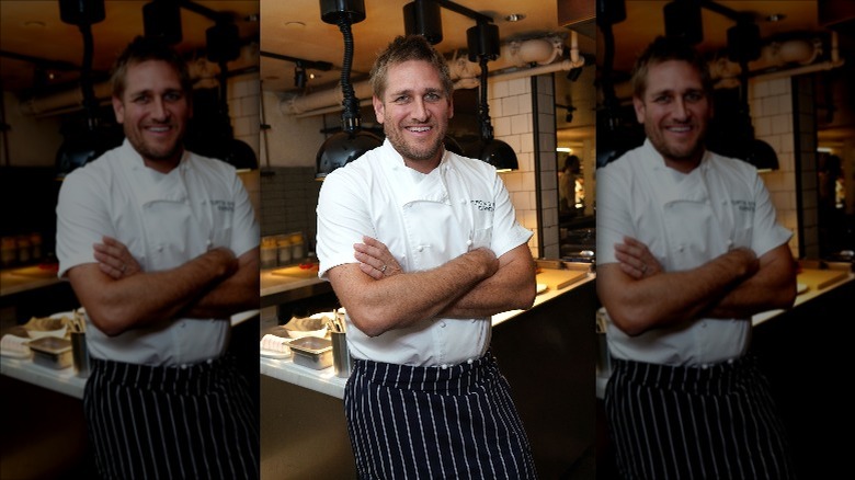 Curtis Stone stands in kitchen