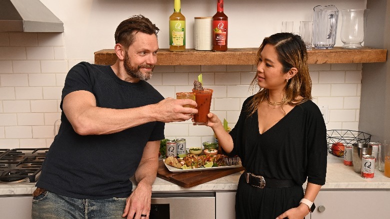 Joel McHale and Esther Choi toasting