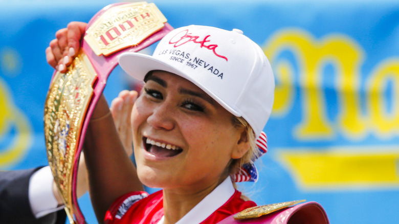 Miki Sudo holding victory belt