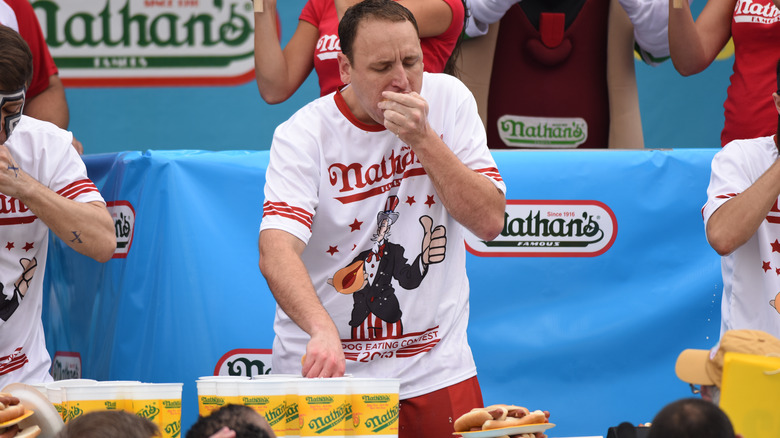 Joey Chestnut eating hot dogs during competition