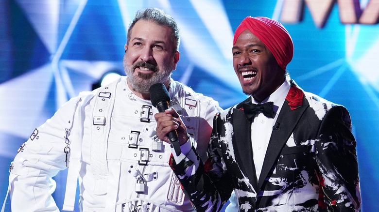 Joey Fatone and Nick Cannon sharing a microphone