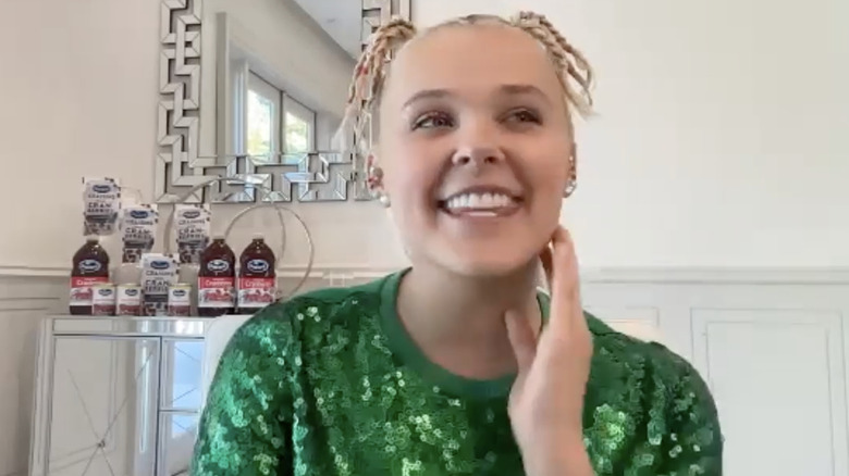 JoJo Siwa with Ocean Spray bottles behind her