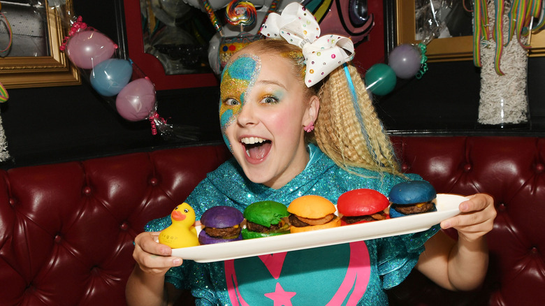 JoJo Siwa holding burgers