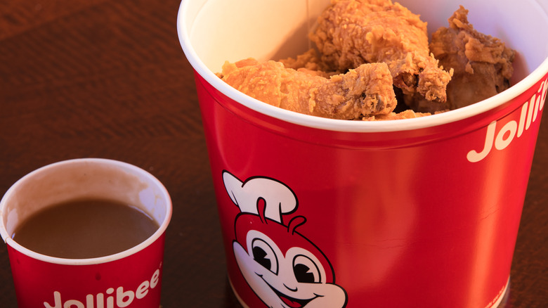 Jollibee chicken and gravy in a red bucket