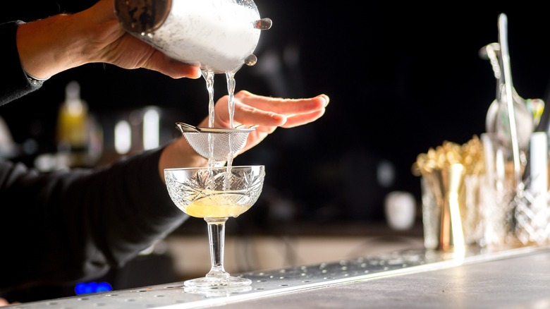 Bartender pouring cocktail