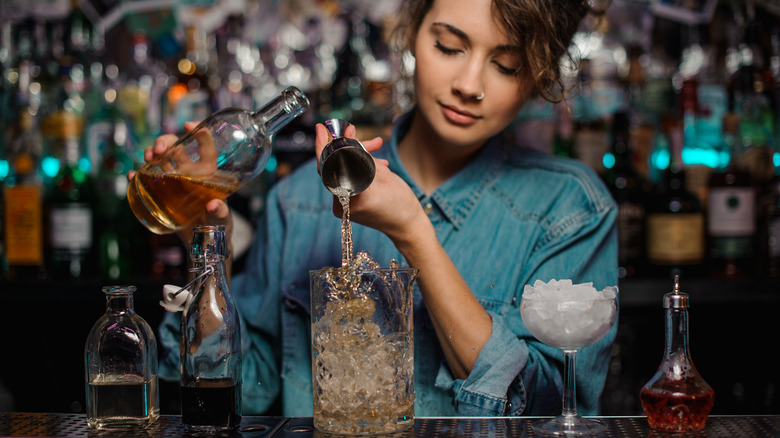 A bartender mixing drinks