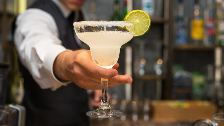 A bartender serving a drink