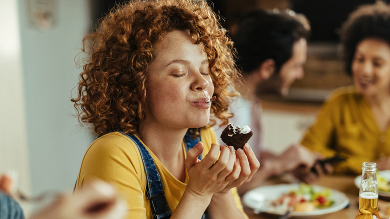 woman eating with eyes closed