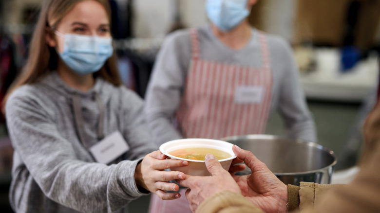 Refugee receiving soup