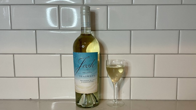 white wine with blue label and glass