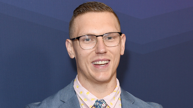 Josh Scherer wearing suit and glasses