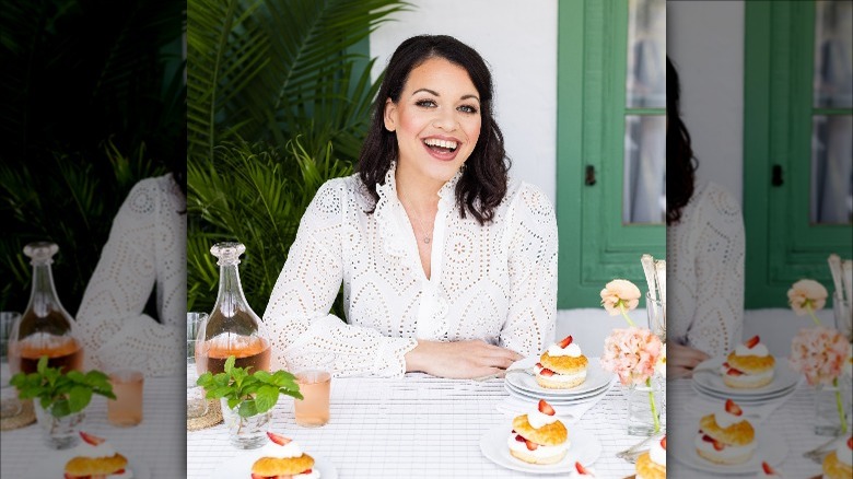 Joy the Baker sitting at a table