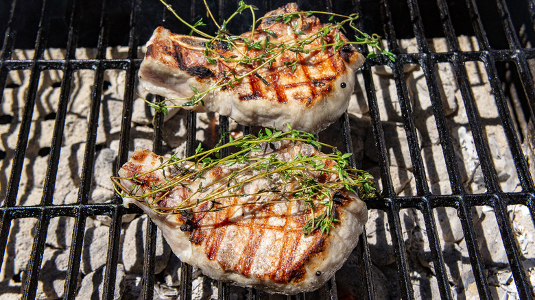 two pork chops on grill