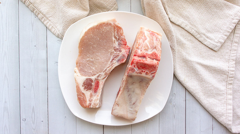 raw pork chops on plate