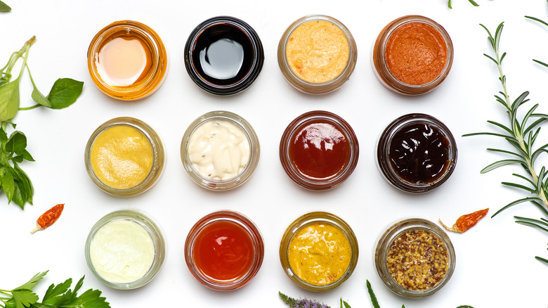 Top-down view of different condiments in jars