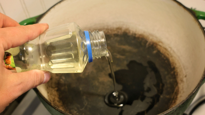 pouring oil into dutch oven