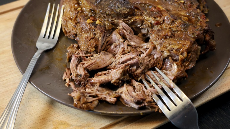 plate of beef and two forks