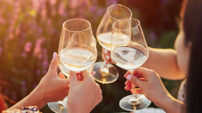 group with glasses of white wine on ice