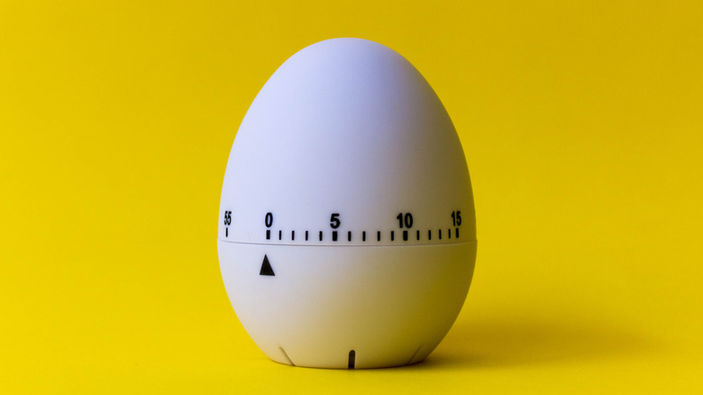 egg-shaped timer against a yellow background