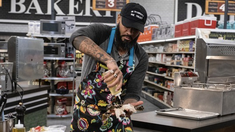 Justin Sutherland grilling during competition