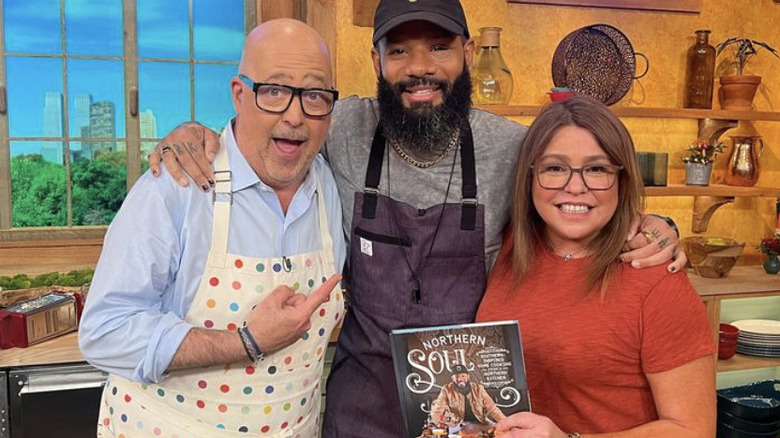 Andrew Zimmern, Justin Sutherland, and Rachael Ray posing with cookbook