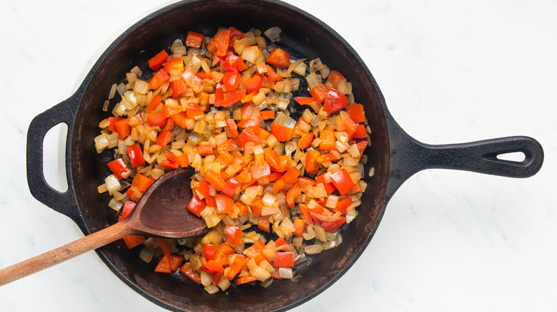 Onion and red pepper frying in skillet