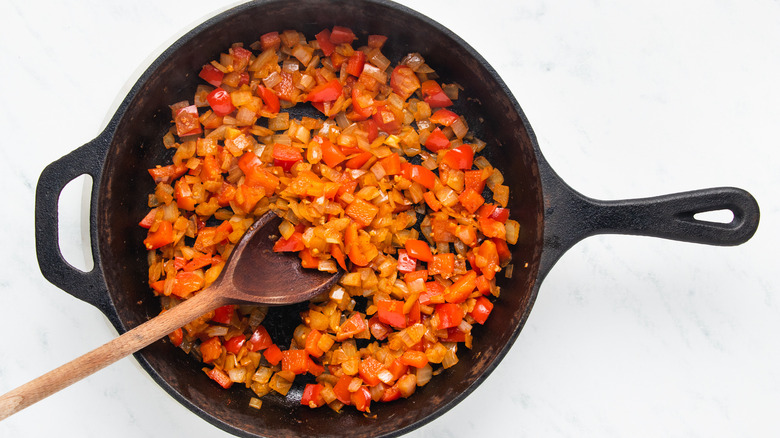 Onion and red pepper frying in skillet