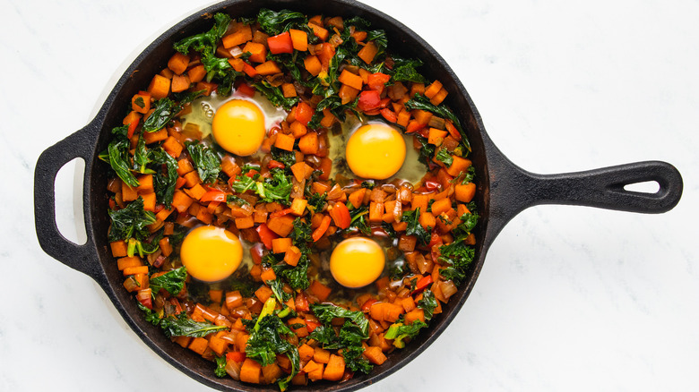 Vegetables and eggs in skillet