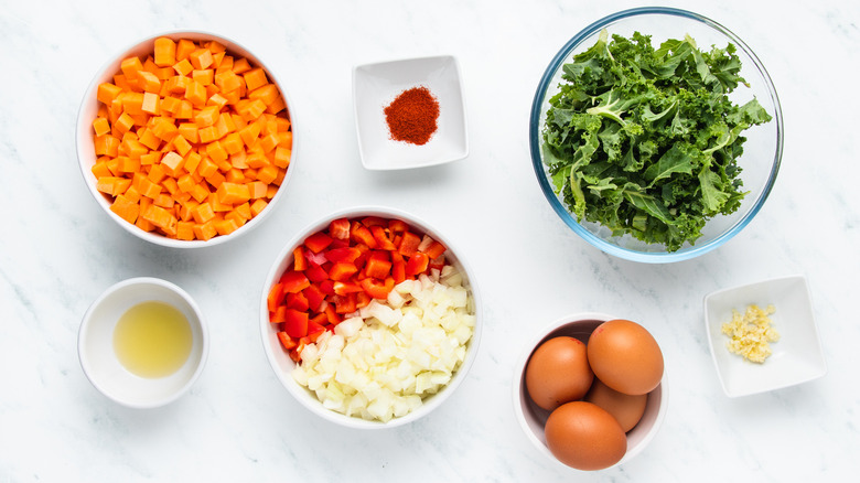 Kale and sweet potato hash ingredients in bowls