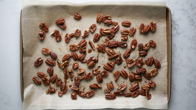 maple pecans on baking sheet